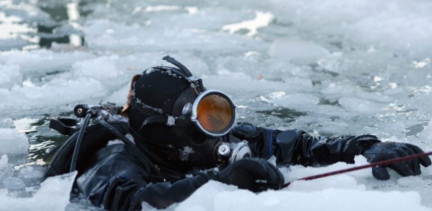 A diver resurfaces in Antarctica amidst the brash ice