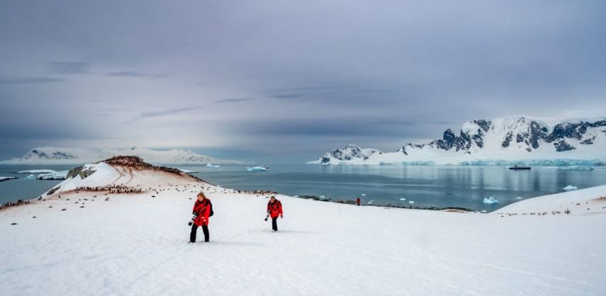 Two photographers return from photographing a gentoo penguin Rookery on the Antarctic Peninsula