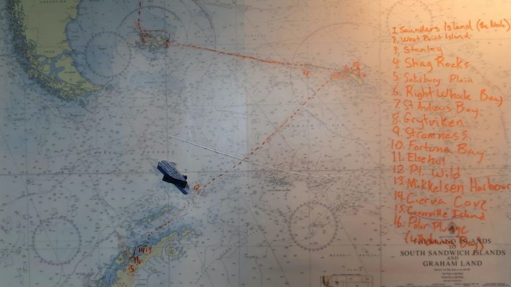 A ship's chart of Antarctica, South Georgia, the Falklands and Tierra del Fuego, with a hand-marked route between destination plotted on it, listing the places visited by an expedition cruise ship.
