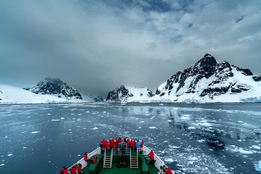 Tourists at the bow of a ship in Antarctica