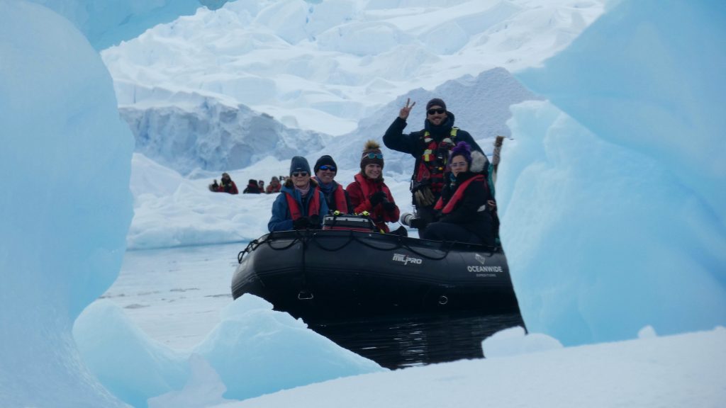 Tourists and iceberg in Antarctica